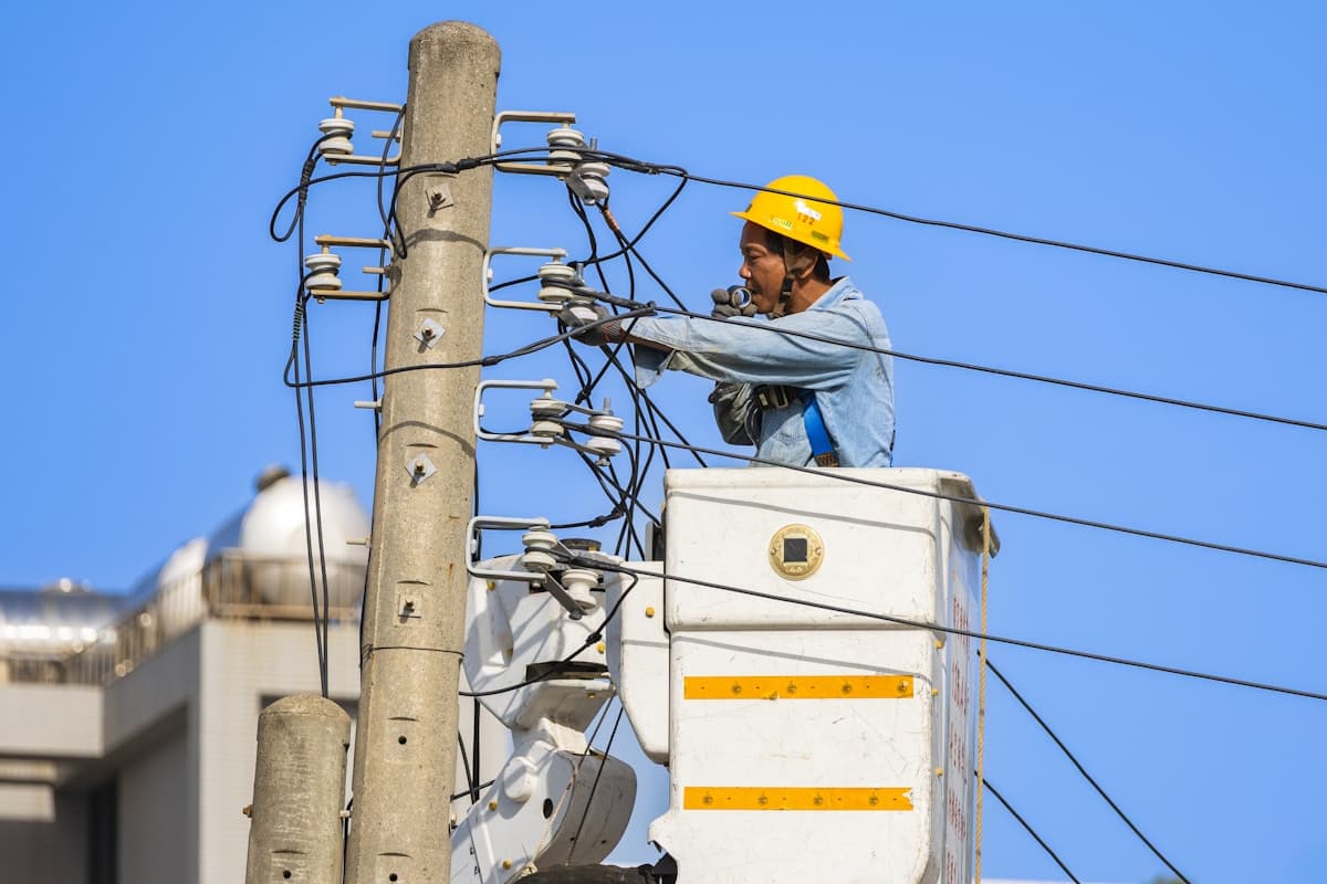 Electrician working on live electrical infrastructure equipment