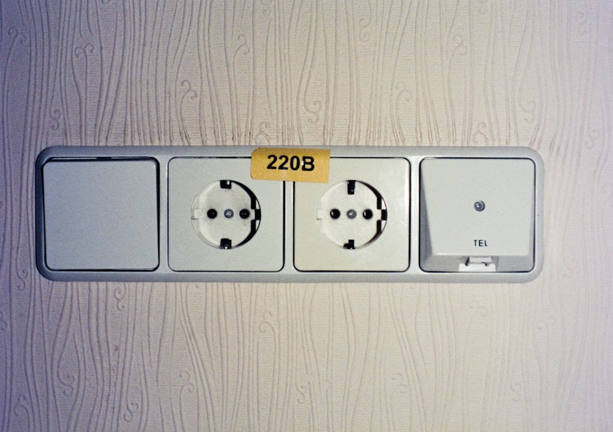 Electrical outlets and wall switch installed on a textured interior wall